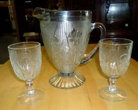 Pitcher and two glasses with flowers