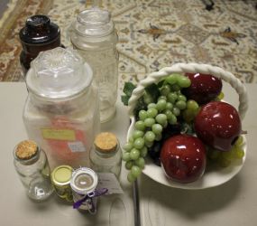Various Glass Jars and White Porcelain Basket with Fruit