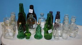 Large Group of Clear Glass, Colored Glass Bottles and a Decanter