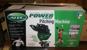 Atec Power Streak Pitching Machine New in box, includes group of soft balls.