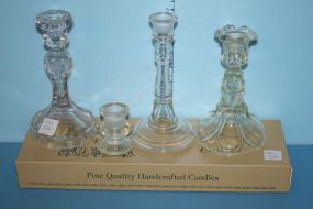 Four Various Glass Candlesticks and a Box of Candles