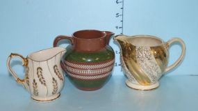 Two Sadler Cream Pitchers and an English Pottery Green and Brown Pitcher