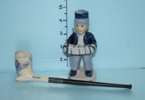 Blue Delft Pipe and a Figurine of a Boy with an Accordion