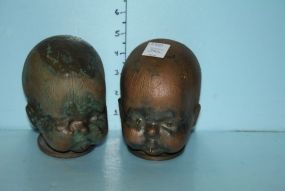 Pair of Bronze Baby Heads