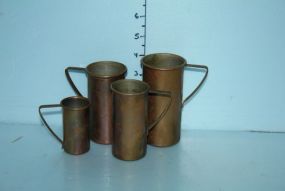 Group of Four Brass Measuring Cups