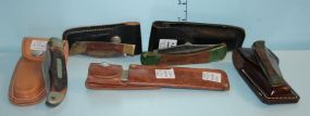 Group of Four Pocket Knives with Sheaths and an Older Timer Hone Steel