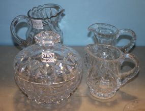 Three Glass Pitchers with a Glass Covered Dish