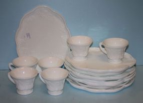 Seven Oval Milk Glass Saucers and Six Cups