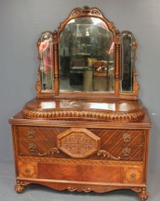 Kidney Shaped 1940s Walnut Veneer Dresser with Beveled Swing Out Mirrors Two serpentine drawers, three long drawers with elaborate carving all supported by carved bun feet. Matches previous lot 51