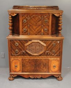 Rare 1940's Walnut Veneer Chest of Drawers With lift top, elaborate carvings, turned post all supported by carved bun feet. Matches previous lot. 38