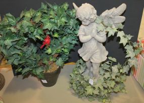 Resin Angel Angel with artificial vine and flower pot with greenery.