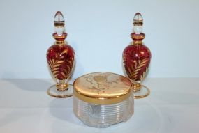 Two Rose Color Perfumes with Stoppers and Rose Colored Covered Powder Jar Description