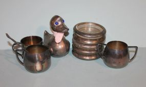 One Silverplate Duck Bank, Five Silverplate Ashtrays, One Community Plate Cup and Two Quadruple Plate and Spoons Description