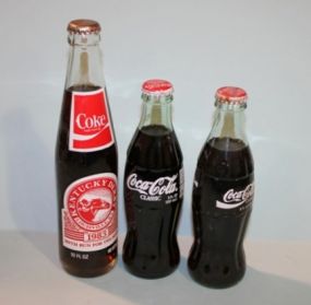 Three Unopened Commemorative Coca Cola Bottles Description