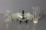 Two Glass Pitchers and Thirteen Clear Glass Bone Dishes Description