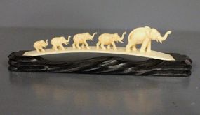 Decorative Elephant Figurines on Wooden Stand Description