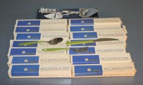 Fourteen Boxes of Stainless silverware and One Mirage by Robinson Cheese Plane Description
