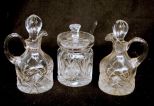 Three Pieces of Waterford Style Cut Glass Which Include Condiment With Spoon And Two Cruet Jars