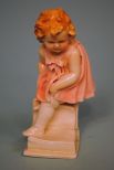 Karl Ens Porcelain Figure of a Little Girl, Dressing Up