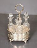 Four Cruet Bottles and Silverplate Stand