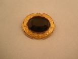 Pretty Gold broach with Black stone insert.