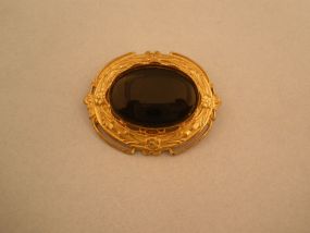 Pretty Gold broach with Black stone insert.