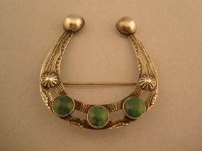 Horseshoe shape Sterling Broach with Turquoise Stones.