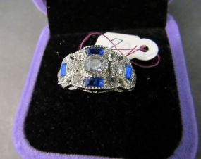 Center Clear Round Stone Ring with Blue and Clear Stone Accents in a Silvertone Setting