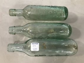 Three Clear Glass Torpedo Bottles