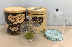 Collectible Tins, Glass Apple, and Glass Dome