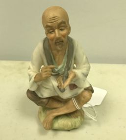 Vintage Oriental Porcelain Man Sitting Smoking a Pipe