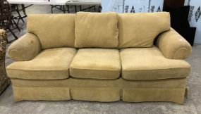 Tan Upholstered Three Cushion Sofa