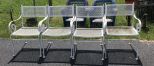 Four White Wrought Iron Patio Chairs