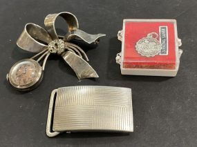 Sterling Flower Clock Brooch, Ladies Sterling Belt Buckle, and Yorktown Charm.