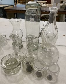 Group of Assorted Glassware Includes Jars, Candle Holders, Flower Vase, and Other Misc Items.