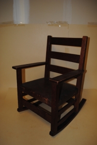 ARTS & CRAFTS OAK CHILDS ROCKER; leather seat; Craftsman paper label to underside, no. 343 New York