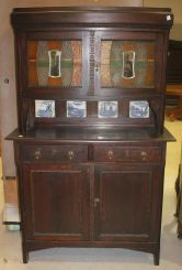 Oak Two Piece Kitchen Cabinet with Blue and White Tiles in Backsplash, Mirrored and Stained Glass Doors on Top