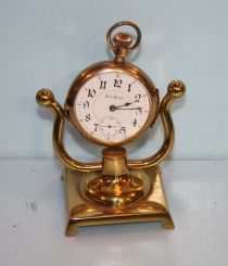 1878 (USA) Brass Wind Clock and an Illinois Watch Company Pocket Watch on Stand