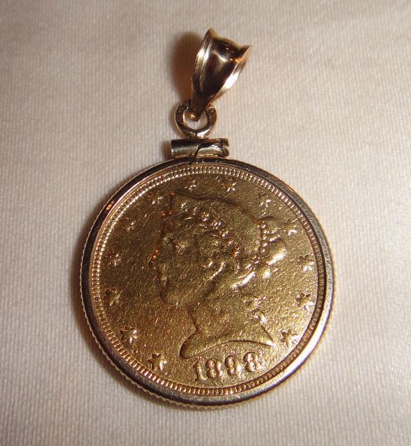 One 21KT and 14KT yellow gold lady's die struck gold coin pendant with a coin edge mounting