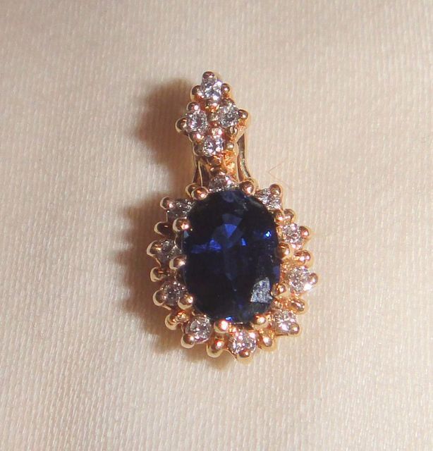 One stamped 14KT yellow gold lady's cast sapphire and diamond pendant
