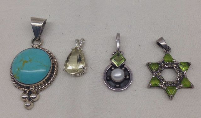 Four sterling Silver lady's pendants