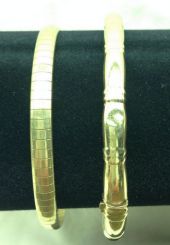 Two Stamped 14K Yellow Gold Lady's Bangle Bracelets with Bright Polish Finish; 21.6 g est.