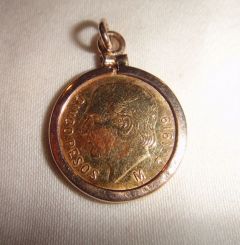 One 21KT and 14KT yellow gold lady's combination cast & die struck gold coin pendant with a bright polish with relief finish. The coin was minted in 1919. The coin is a 