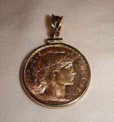One 21KT and 14KT yellow gold gents combination cast & die struck gold coin pendant with a bright polish with relief finish. The coin was minted in 1905. The coin is a 