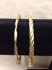 Two stamped 10KT yellow gold lady's bangle bracelets with a bright polish finish. Total Weight of Bracelets 9.70 dwt