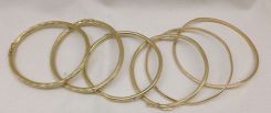 Six Stamped 14K Yellow Gold Lady's Bangle Bracelets with Bright Polish Finish; 30.7 g est.